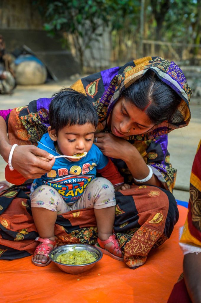Mother feeds her child nutritious meal in Bangladesh. 