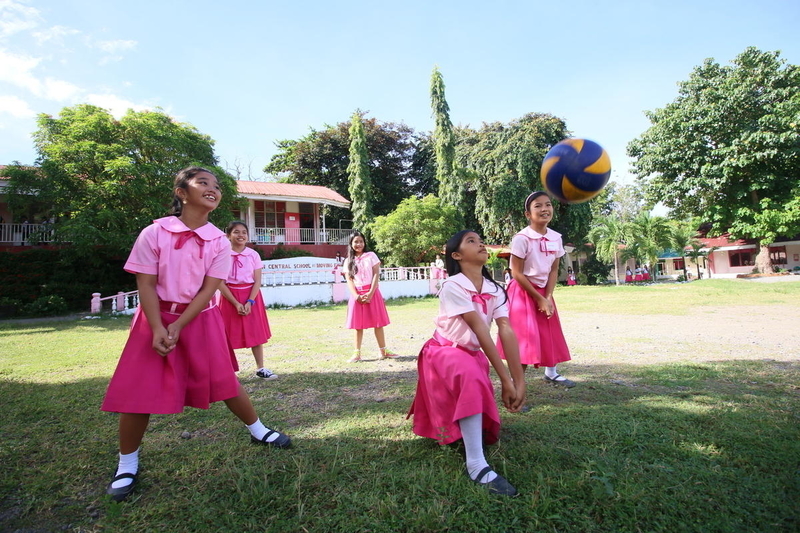Girls play volleyball at a school in the Philippines. 