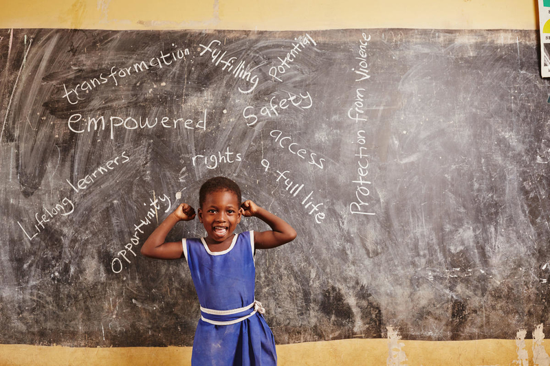 girl in front of chalk board in Ghana