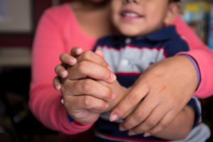 A 24-year-old woman and her 4-year-old son arrived at Sacred Heart after going through the U.S. Border Patrol Processing Center on July 31, 2014 after a month long joinery from El Salvador. At Sacred Heart they received food, clean clothes, new shoes, a shower, and a place to rest while they waited to catch the bus that would take them to Houston. There they will reunite with her aunt until their hearing date in immigration court.