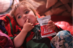 Nasima holding a RUTF packet that she just received from a World Vision Mobile Health Team. Hunger is on the rise around the world.