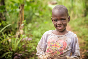 Photo: Three of Josephine’s daughters died of HIV and AIDS. Now she cares for their children, one of whom is pictured, at her home in Uganda. ©2016 World Vision, Jon Warren.