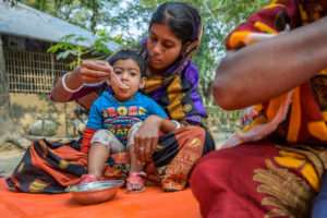 Mom feeds her baby with nutrition food