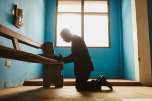 pastor praying in Ghana