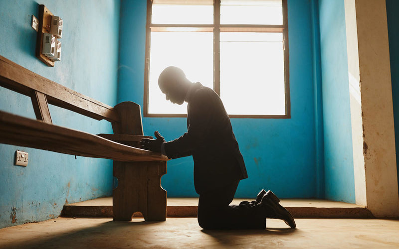 pastor praying in Ghana