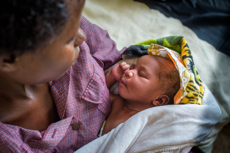 Mom and baby at clinic that helps improve maternal health
