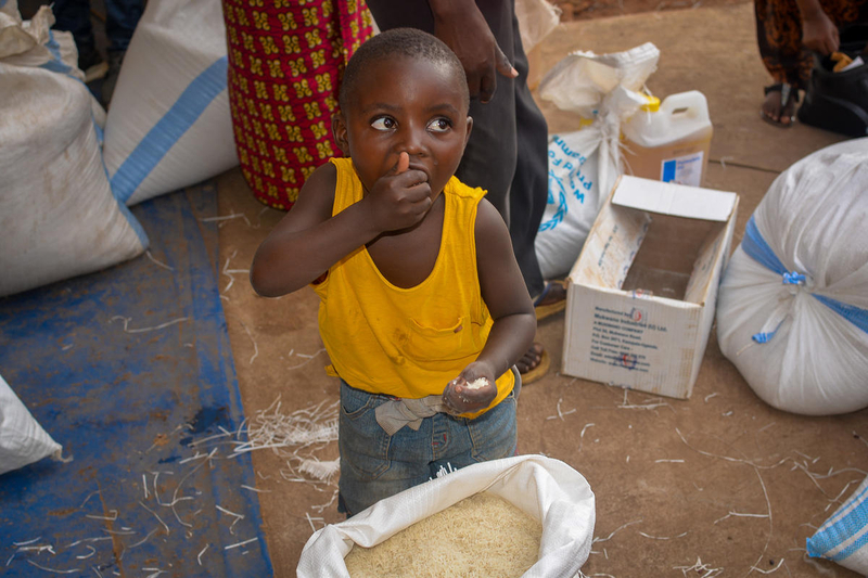 Child samples food from World Food Porgram