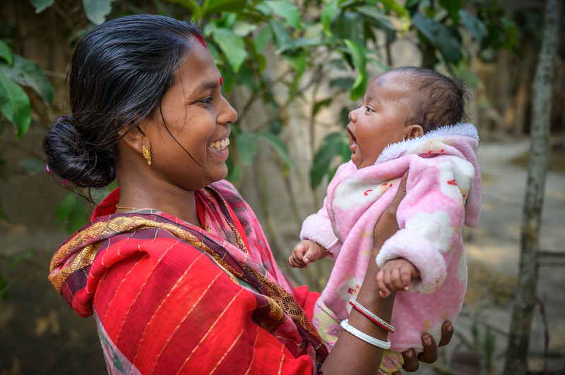 Mom smiles at her baby daughter