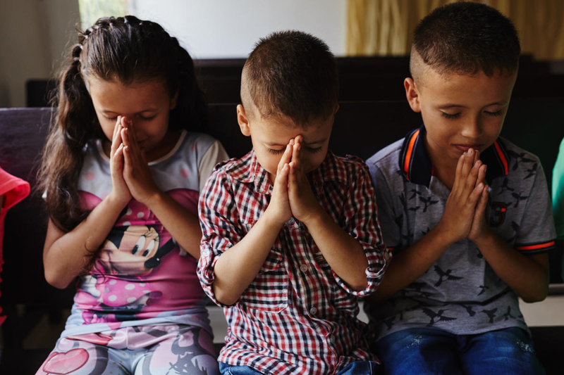 Three children praying