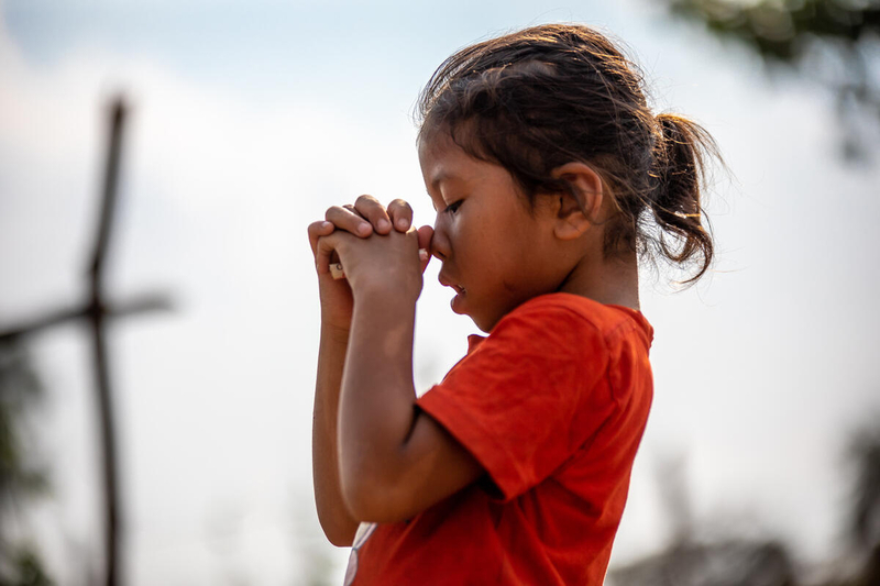 Girl praying in Cambodia