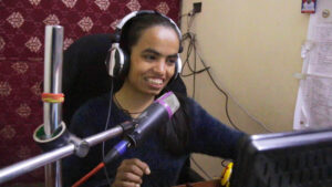 Young girl giving radio broadcast