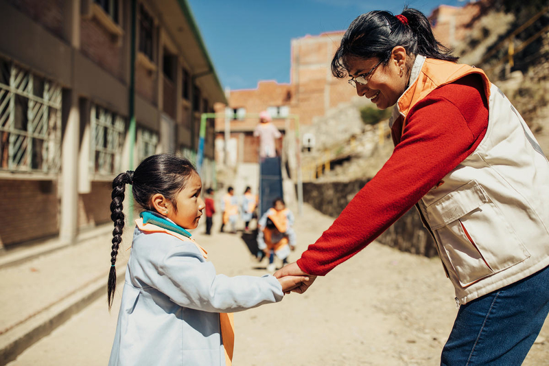 World Vision staff member with child in Bolivia