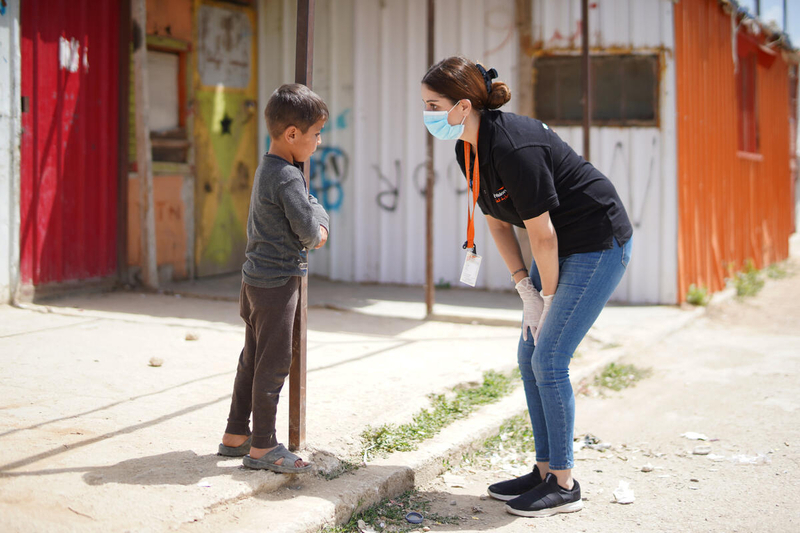 World Vision staff talks to Syrian boy